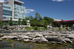 An outside view of Richcraft Hall from the viewpoint of the river