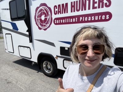 Stéfy McKnight poses in front of the CAM HUNTERS RV