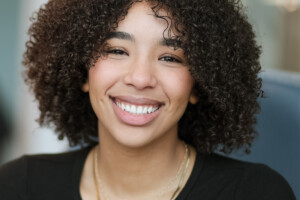 Image of a female student smiling against a blurry background