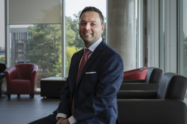 Daniel Rosenbloom poses against a background of Richcraft Hall