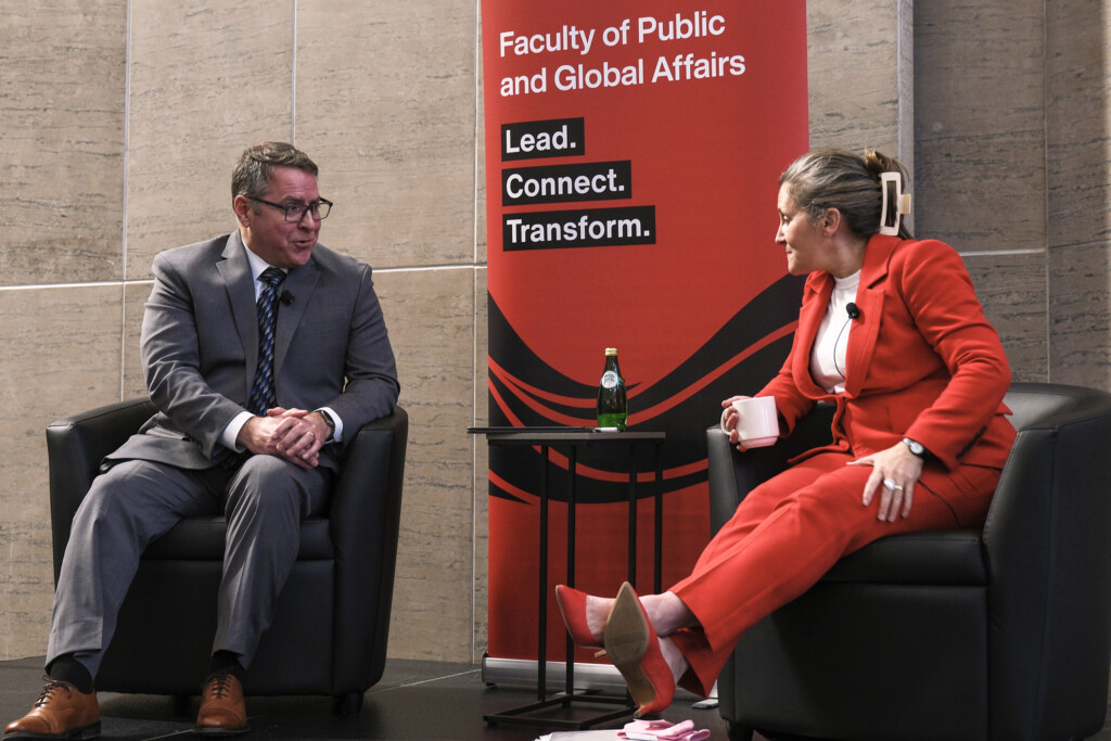Moderator Paul Goode on stage with the Honourable Chrystia Freeland during the 2026 Bell Lecture