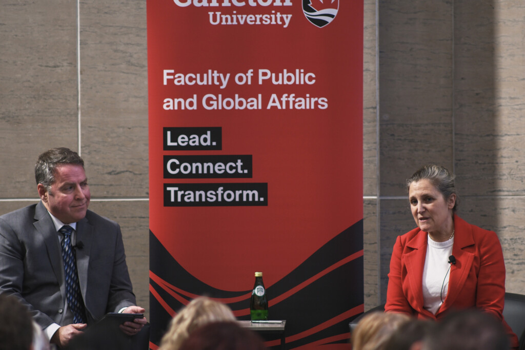 Moderator Paul Goode on stage with the Honourable Chrystia Freeland during the 2026 Bell Lecture