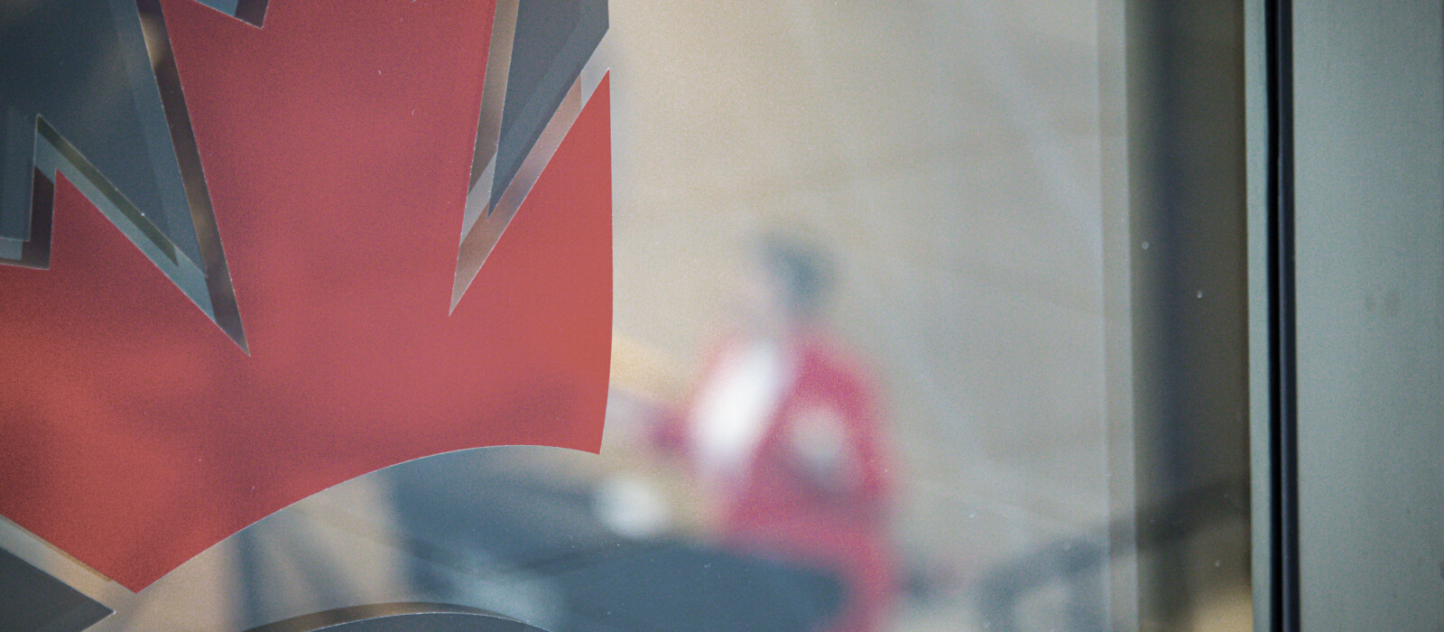 Artistic shot of the Carleton logo with a blurred Honourable Chrystia Freeland in the background