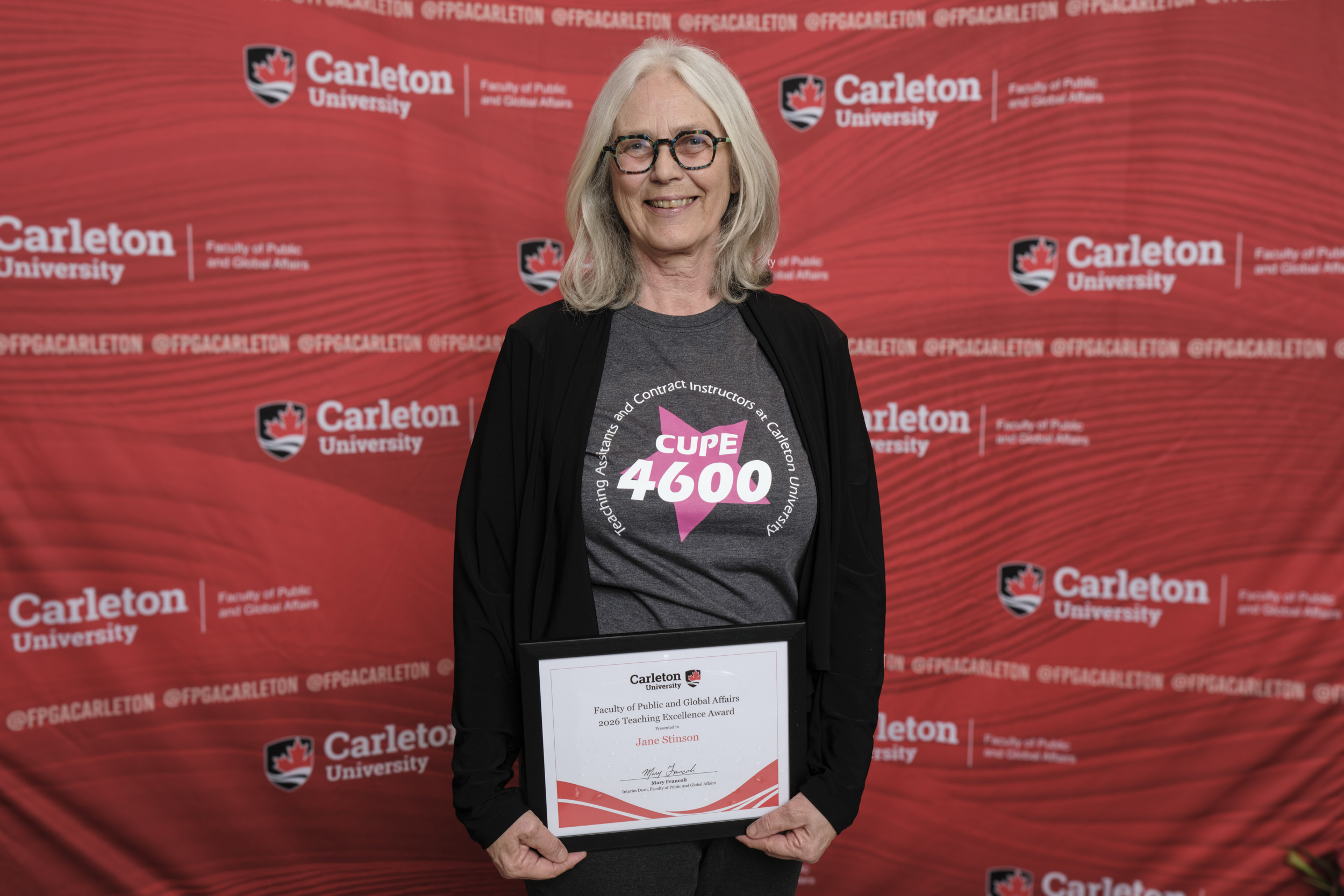 Jane Stinson poses with the 2026 Teaching Excellence Award