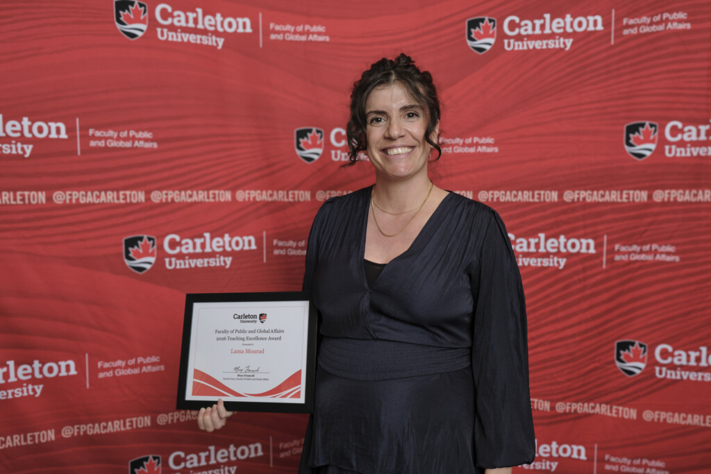 Lama Mourad poses with the 2026 Teaching Excellence Award