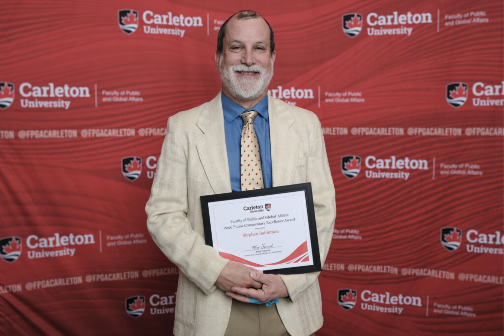 Stephen Saideman poses with the 2026 Public Commentary Excellence Award