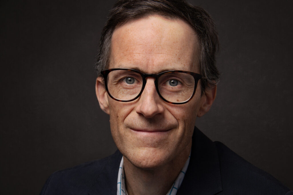 Photo of Graeme Auld on a grey background