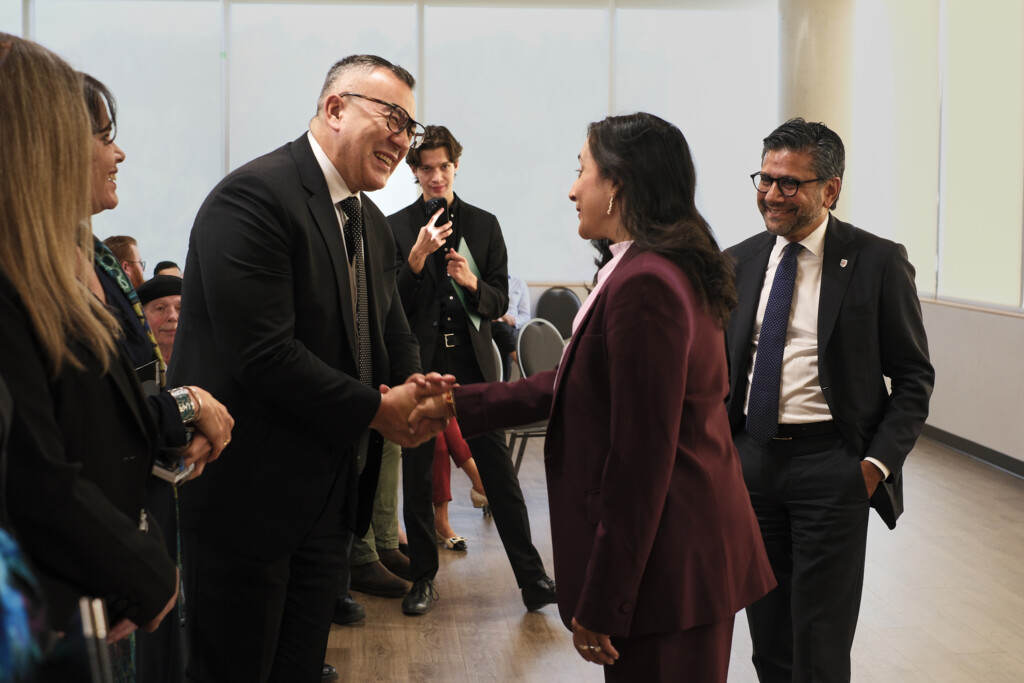 Minister Anand greeting an audience member