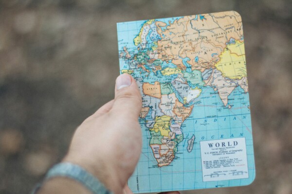 Hand holding a world map outdoors