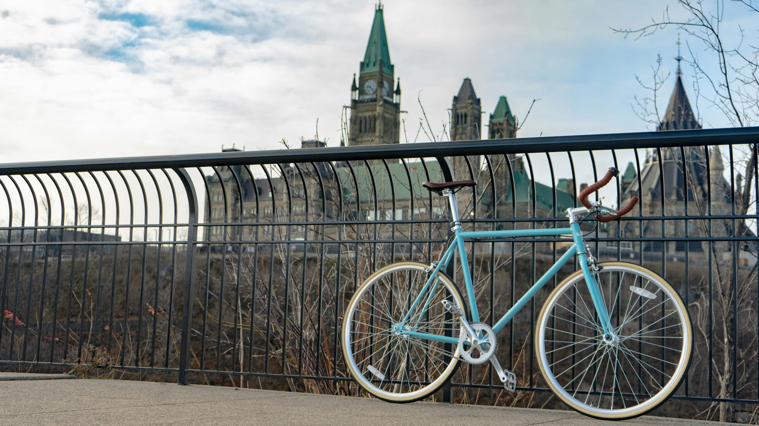 blue bike with parliament buildings in distance