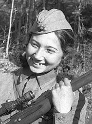 photo of a girl holding a rifle and smiling