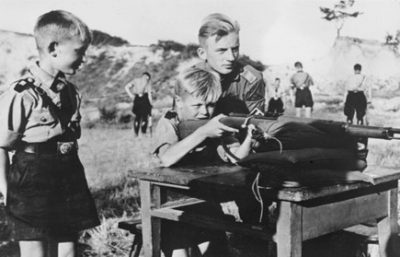 Eleven-year-old boys in the Hitler Youth organization learning how to fire a rifle