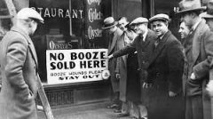 men standing outside a restaurant with a sign that says no booze sold here