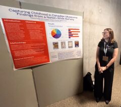 Rebecca Friend next to her poster