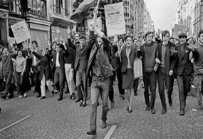 photo of teenagers carrying pickets and marching in the street