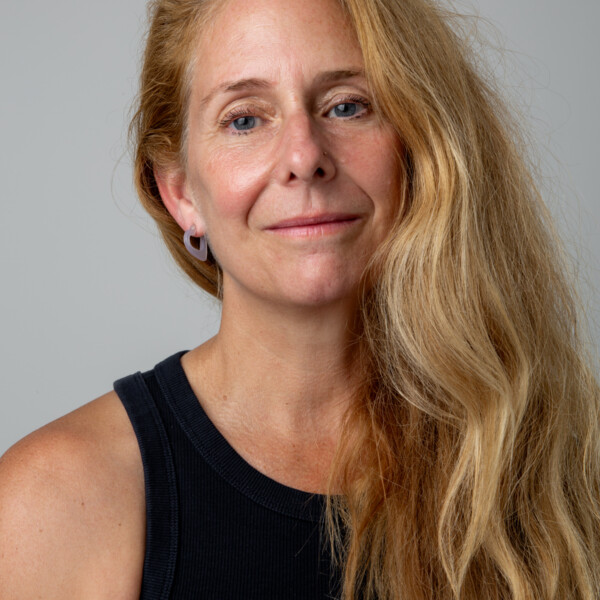 Jen Evans standing in front of a grey wall