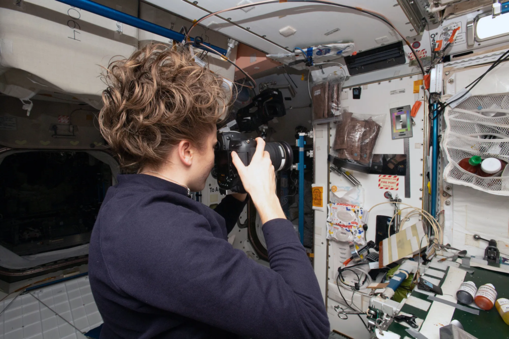 NASA astronaut Kayla Barron documents a section of the ISS for archaeological data. NASA