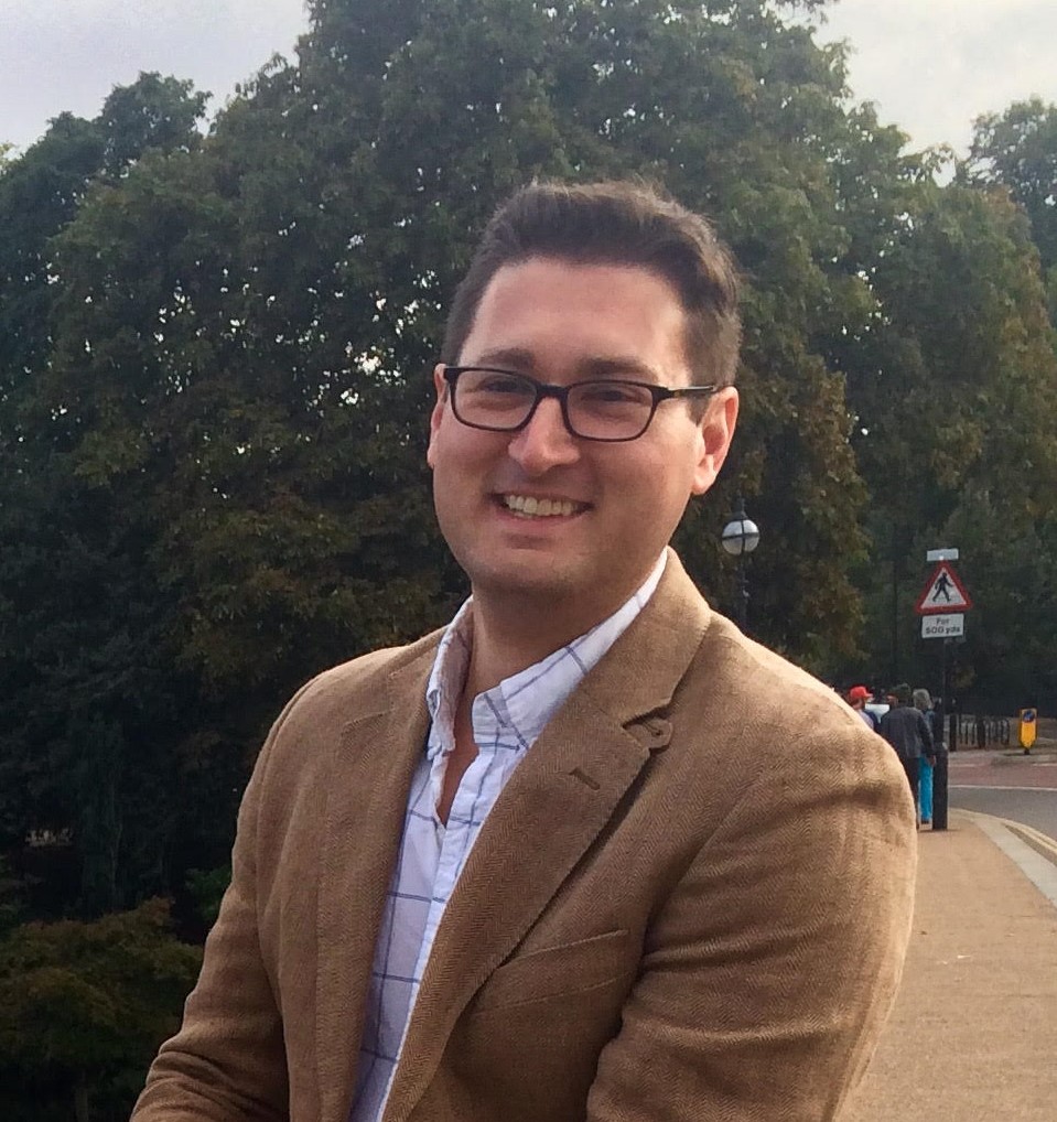 Brian Drohan standing in front of a tree