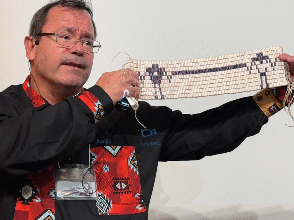 John Moses holding beadwork