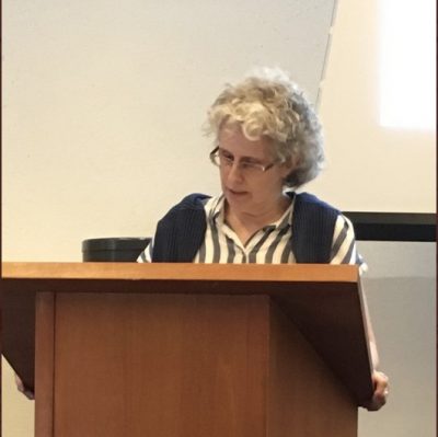 Dominique Marshall standing at a podium speaking