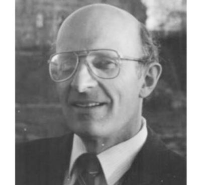 black and white photo of John Taylor wearing glasses