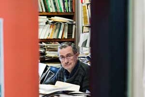 Bruce Elliott in office surrounded by books