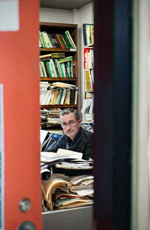 Bruce Elliott in office surrounded by books