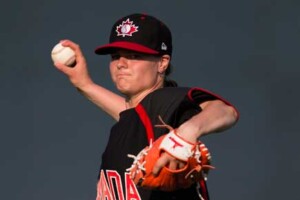 Melissa Armstrong in the middle of throwing a baseball pitch