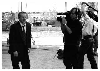 man in suit filmed by cameras