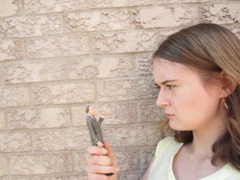 Sarah Cole holding figurine of Sir John A Macdonald