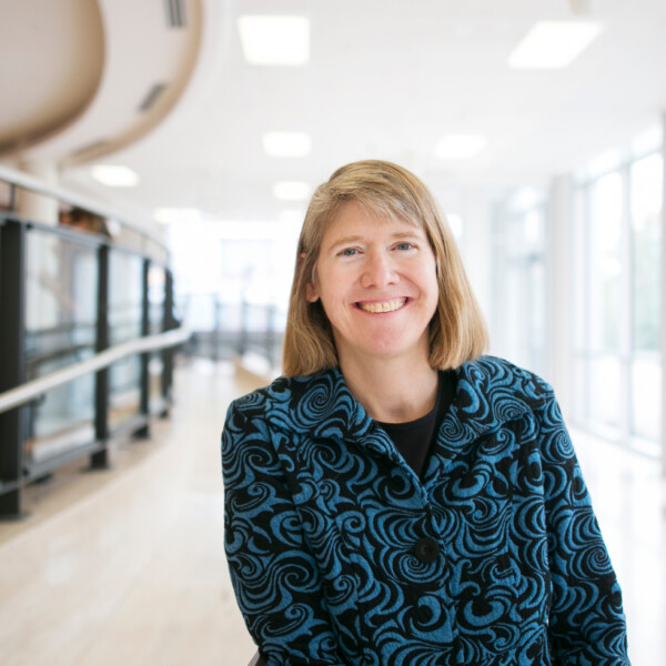 Susan Whitney standing in open area of Tory building