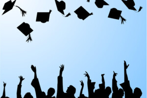 silhouette of grads tossing caps into the air