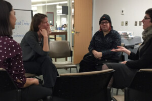seated students speaking together and networking
