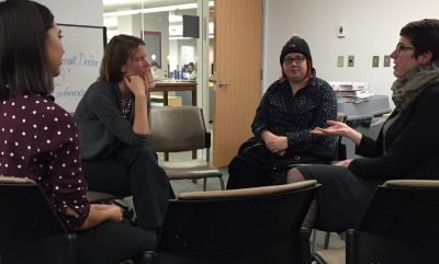 seated students speaking together and networking
