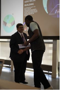 Dr Shah shaking hands with Innovation Hub staff member Cedric