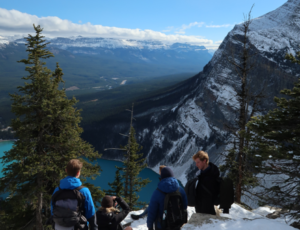 Group of four people hiking in snowy mountains