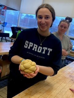 student holding bread dough