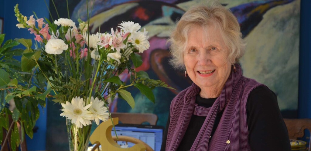 Landon Pearson stands near flowers