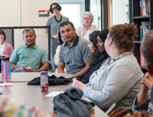 An attendee asks Dr. Ritesh Shah a question during an event in the Migration and Diaspora Studies Lounge.
