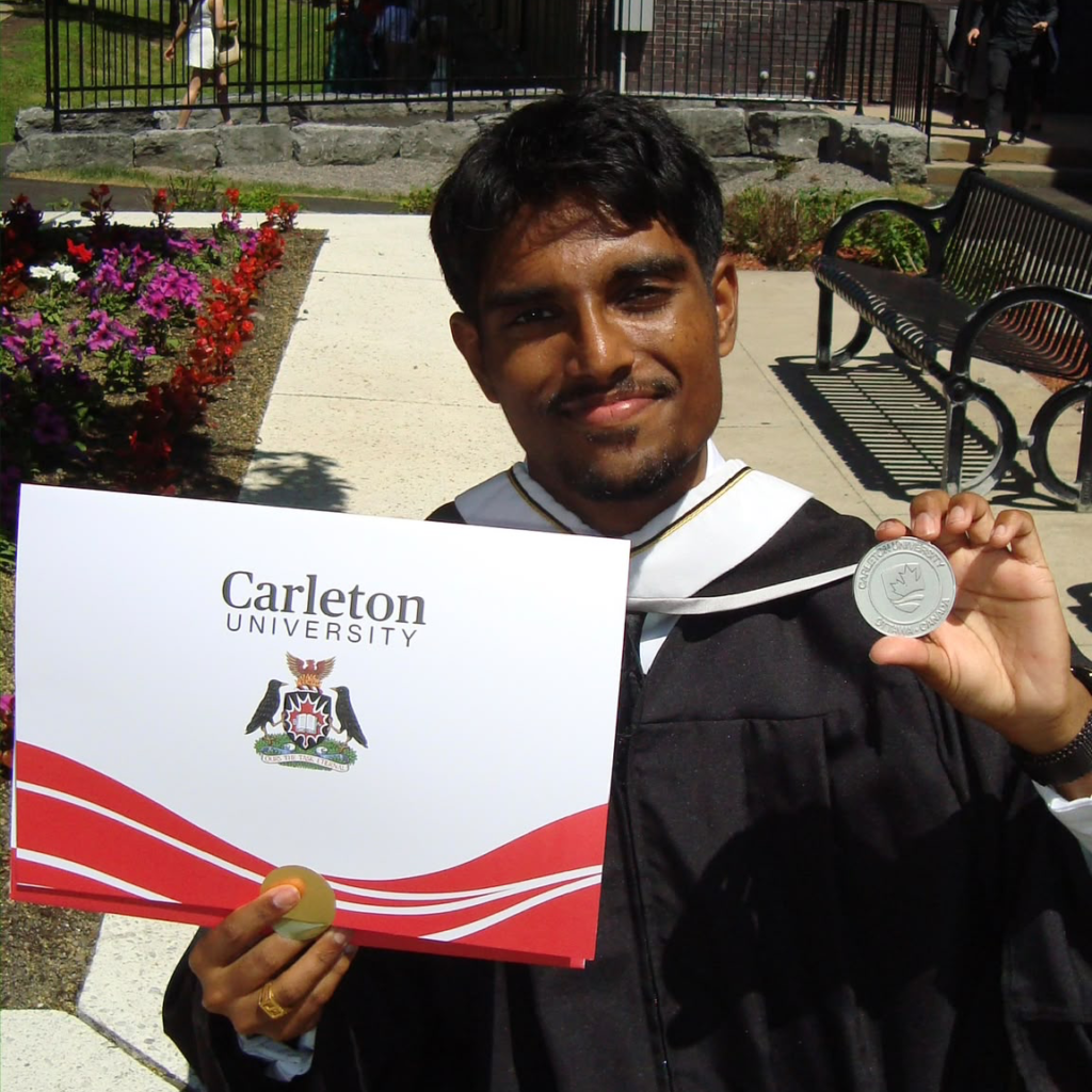 Jarukson holding his degree and medal