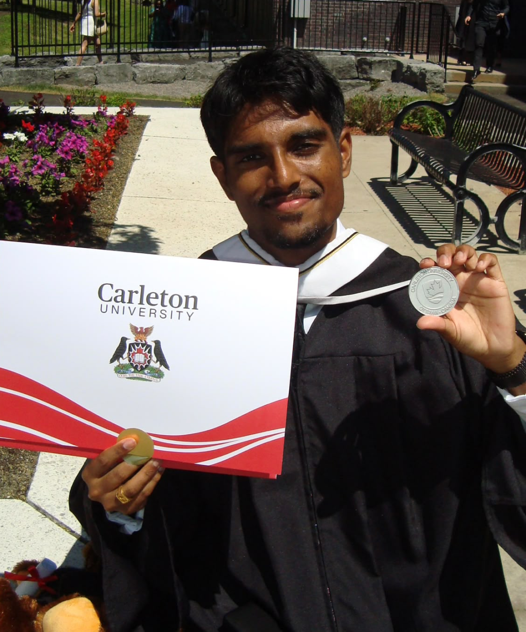 Jarukson smiling while holding his degree and medal