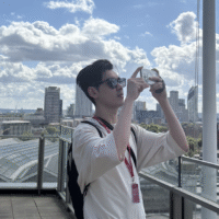 Dylan taking a photo against a city backdrop.