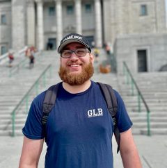 Nick in front of a staircase