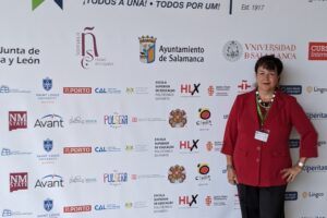 Janett posing in front of poster.