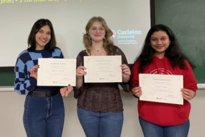 Rachel, Afshan, and Anjali pose with their certificates.