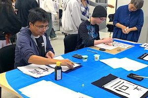 Students working at a table during the event