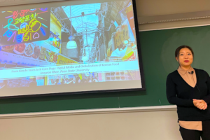 Dr. Jooyeon Rhee in front of her powerpoint