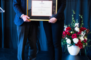 Julie receives award from Jerry Tomberlin