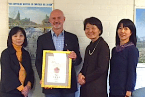 David Wood poses with award and representatives of the Japan Foundation