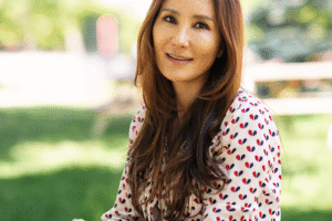 HJ sitting at a picnic table in the quad